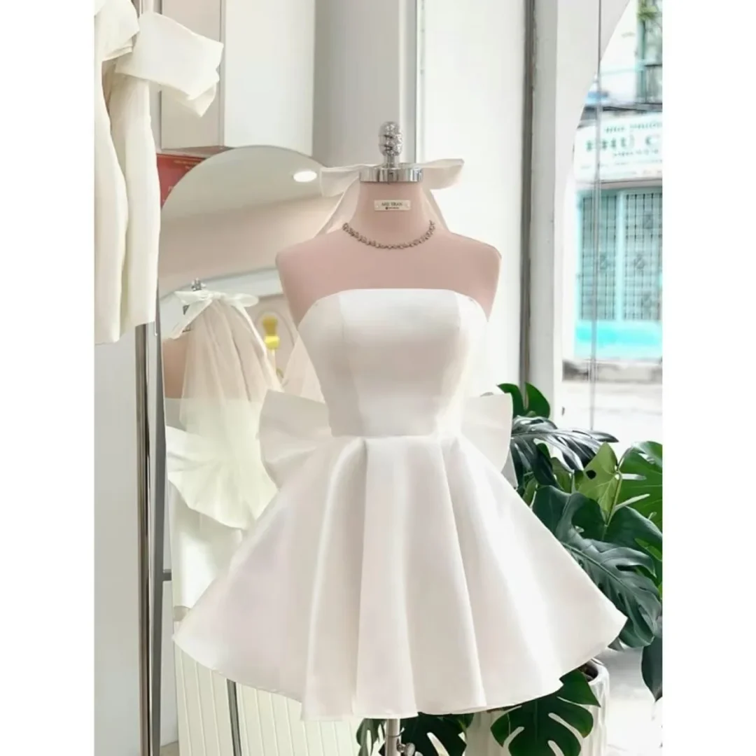 Photo 2 of Váy trắng ngắn nơ lưng satin nữ