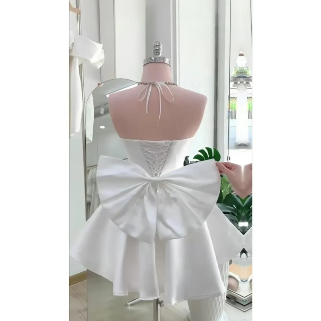 Photo 1 of Váy trắng ngắn nơ lưng satin nữ