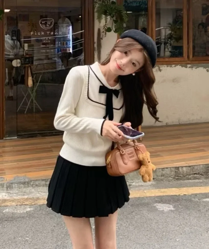 Photo 4 of Set áo len nơ đen chân váy xếp ly nữ size S