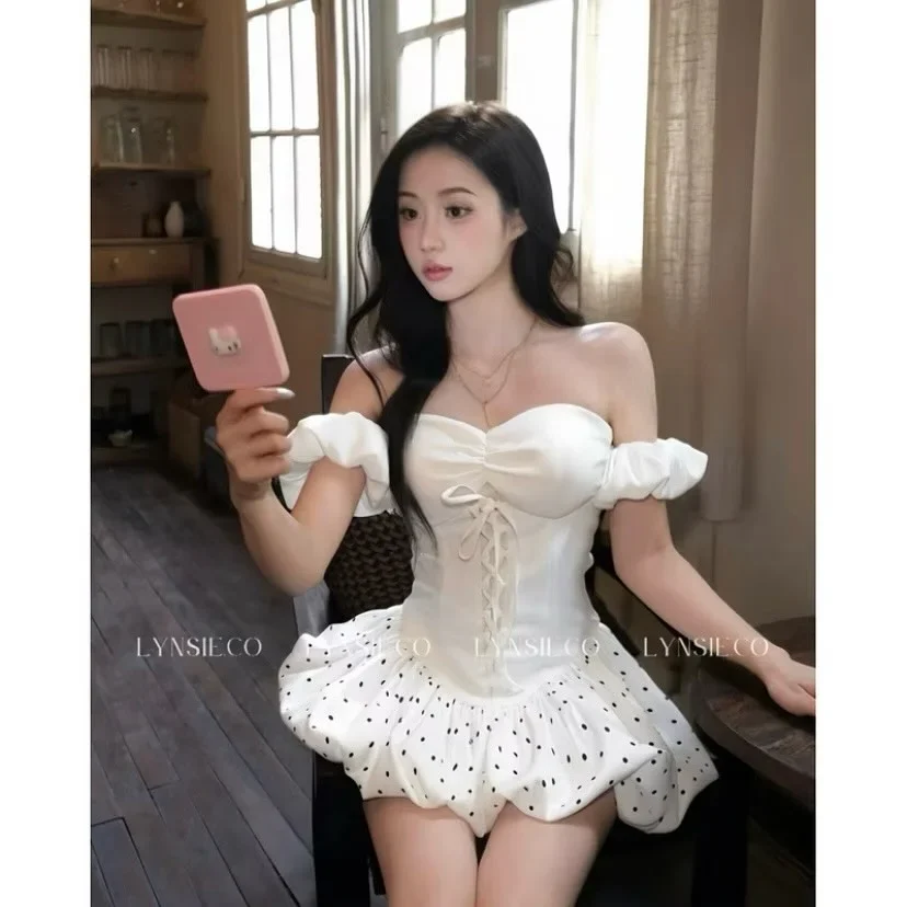 Photo 1 of Bộ corset trắng trễ vai chân váy chấm bi nữ