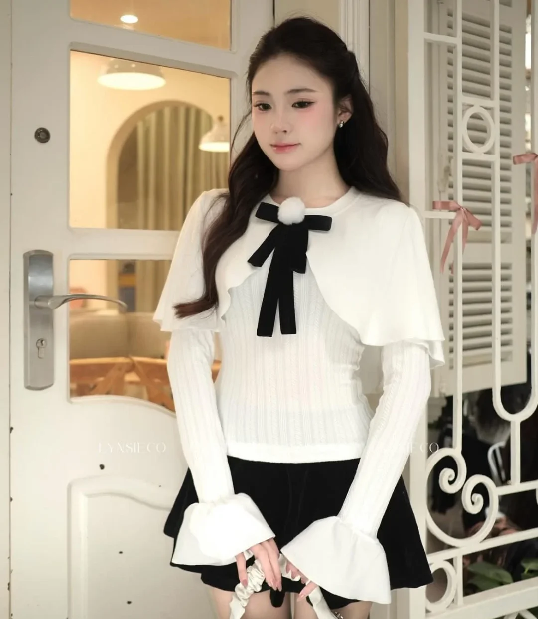 Photo 8 of Áo len trắng nơ nhung tay loe kèm váy đen