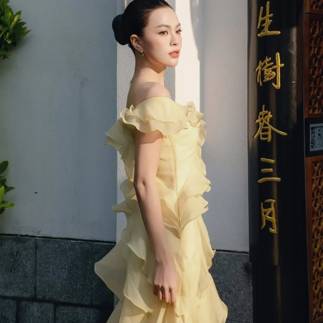 Photo 2 of Váy dự tiệc trễ vai ruffle vàng nhạt NAN